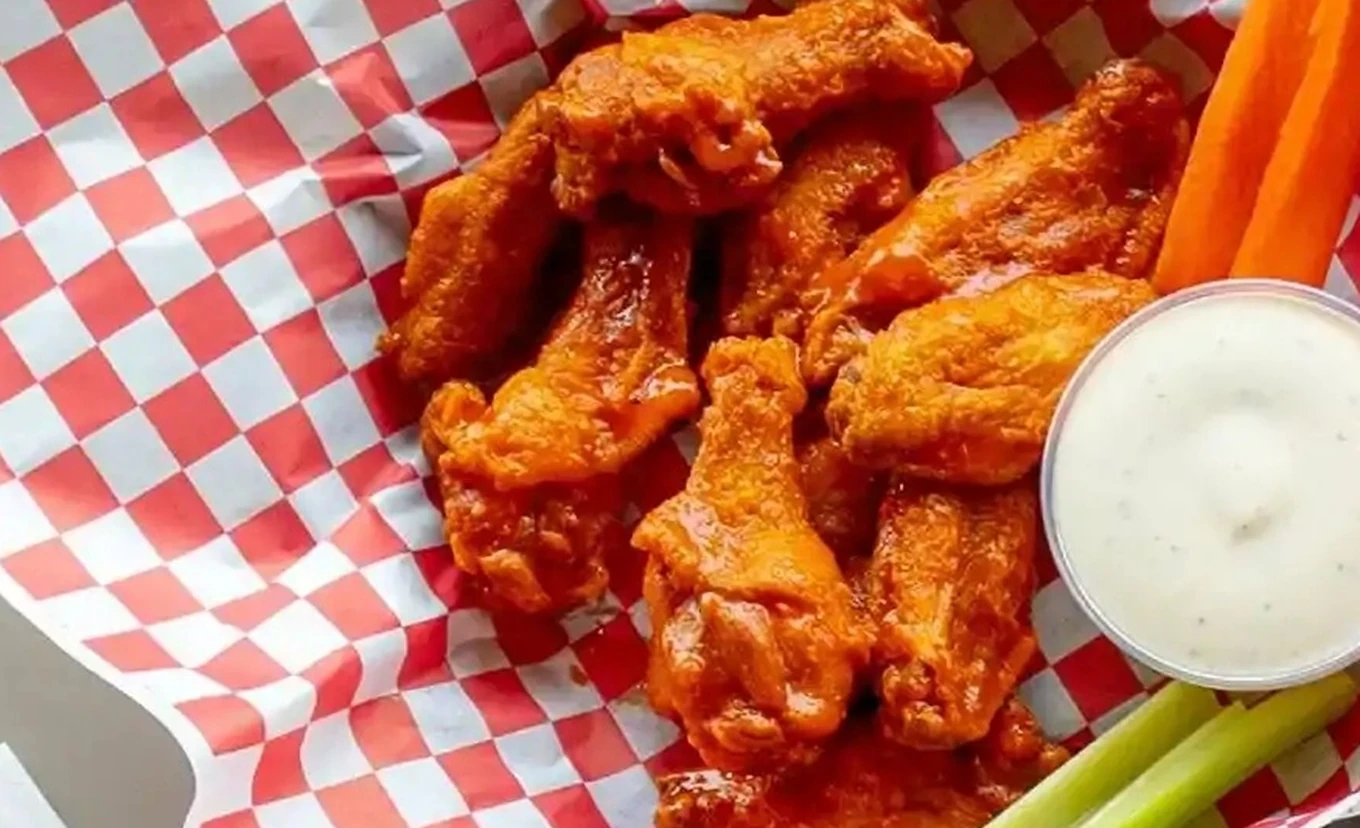 Chicken wings and baked entrees served at Basile's 2 For 1 Pizza & Pasta in Beaumont, AB