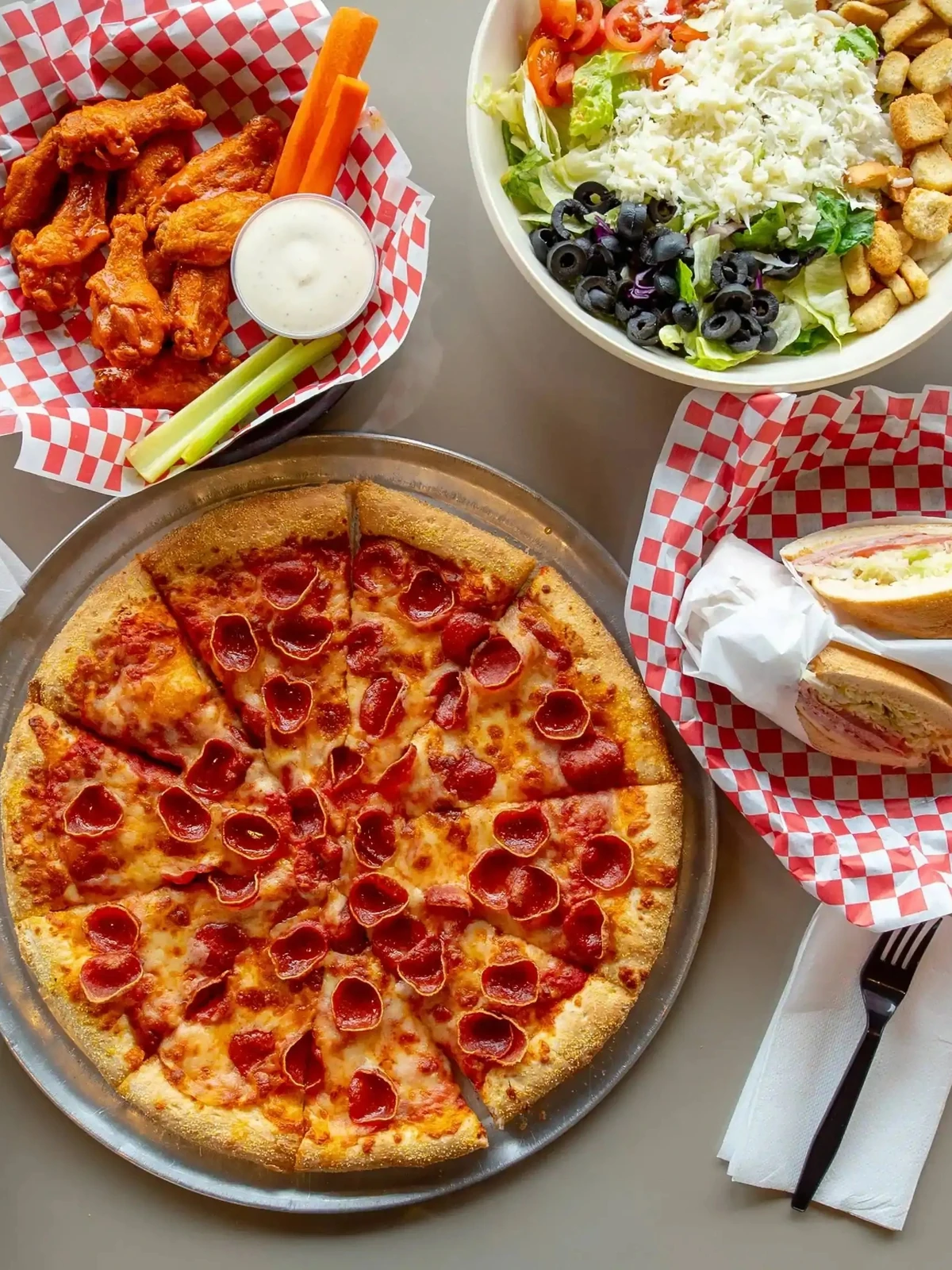Pizza and pasta catering trays for parties and group orders at Basile's 2 For 1 Pizza & Pasta in Beaumont, AB