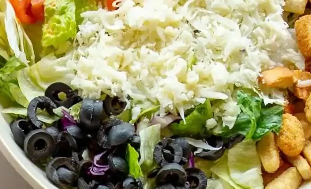 Fresh garden side salad with olives and feta at Basile's 2 For 1 Pizza & Pasta in Beaumont