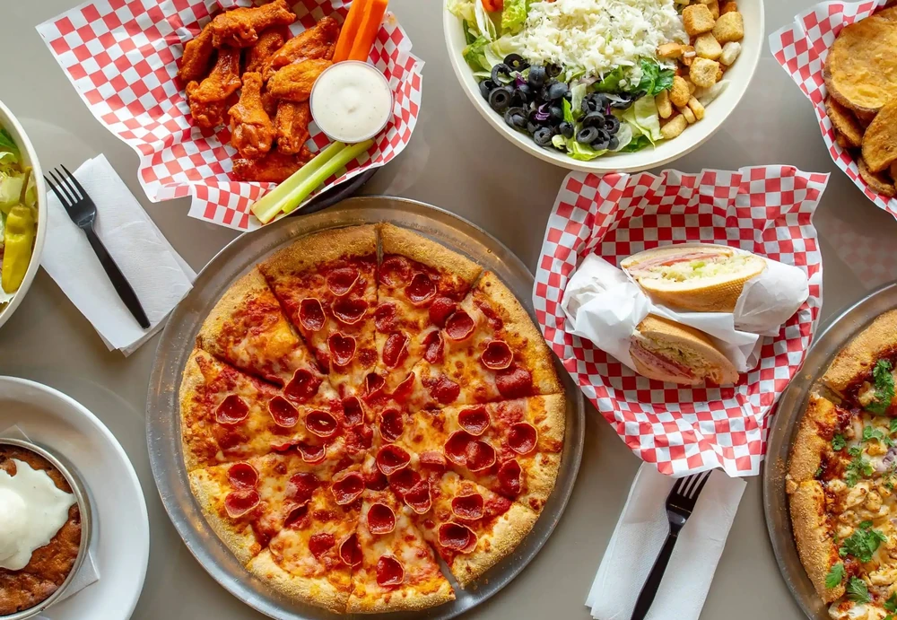 Family-style pizza and pasta combo at Basile's 2 For 1 Pizza & Pasta Beaumont AB