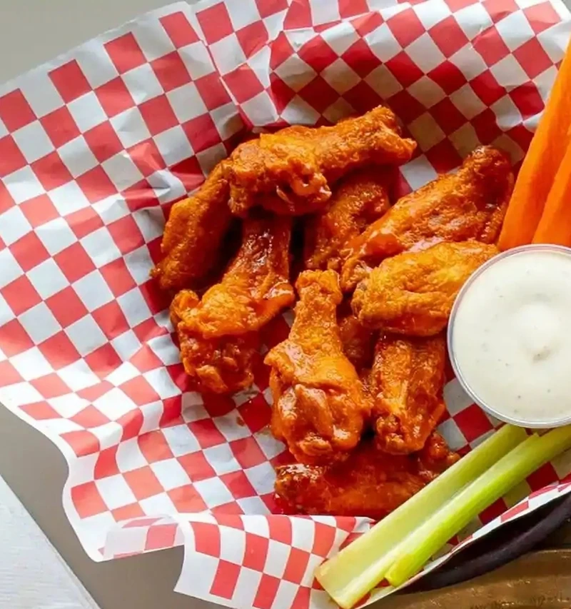 Chicken wings with celery and dip at Basile's 2 For 1 Pizza & Pasta in Beaumont, AB